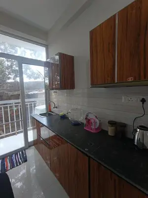 a kitchen with a counter and a window with a view at 1bhk Kalp Guruvayur 150m to temple in Trichūr