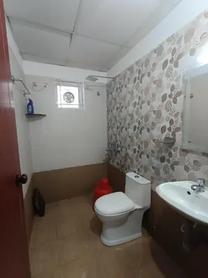 a bathroom with a toilet and a sink at 1bhk Kalp Guruvayur 150m to temple in Trichūr