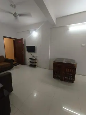 a living room with a couch and a tv at 1bhk Kalp Guruvayur 150m to temple in Trichūr
