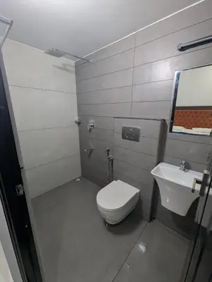 a bathroom with a toilet and a sink at Nana's Residency in Ernakulam