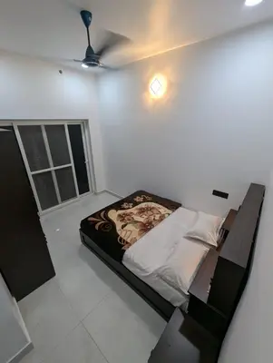a bedroom with a bed and a ceiling at Nana's Residency in Ernakulam