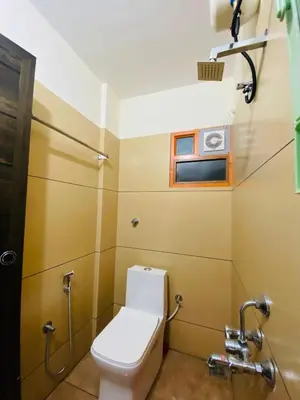 a small bathroom with a toilet and a window at Apartment in Guruvayur- Sooryamadhavam-only for families in Guruvāyūr