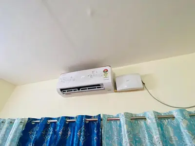 a air conditioner on the wall of a bedroom at Apartment in Guruvayur- Sooryamadhavam-only for families in Guruvāyūr