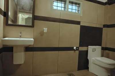 a bathroom with a sink and a toilet at Vista Chembra Service Apartment 20B in Meppādi