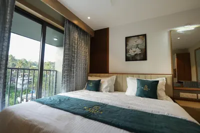 a bedroom with a large bed and a large window at Rasha Suites in Kalpetta