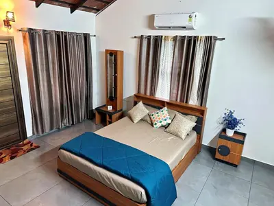 a bedroom with a bed in a room at Bougainvilla in Kozhikode