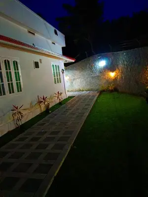 a courtyard of a building at night at White Cloud Stay Attappadi in Agali