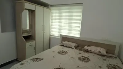 a bedroom with a bed with a mirror and a window at White Cloud Stay Attappadi in Agali