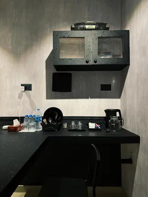 a kitchen with a black counter top in a room at Ebb & Flow in Irimbranallūr
