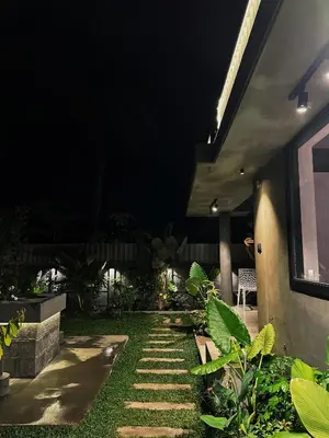 a house with a garden at night at Ebb & Flow in Irimbranallūr