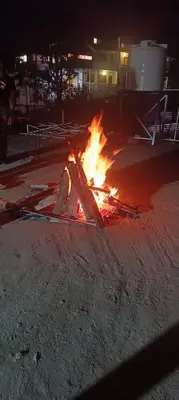 a fire in the middle of a street at night at Msk indian Residency in Kodaikānāl