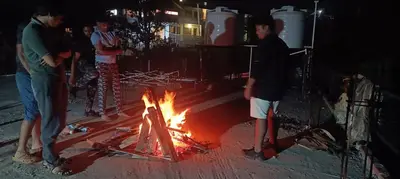 a group of people standing around a fire at Msk indian Residency in Kodaikānāl