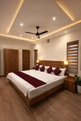 a bedroom with a large white bed with red pillows at Honeymoon holidays in Vythiri