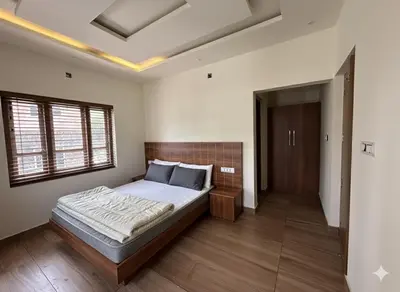 a bedroom with a large bed in a room at Honeymoon holidays in Vythiri