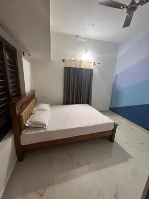a bedroom with a bed in a room at Aarvani Retreat Relax, Explore & Unwind in Coorg in Kushālnagar