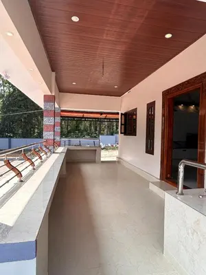 a lobby of a building with benches and a wooden ceiling at Aarvani Retreat Relax, Explore & Unwind in Coorg in Kushālnagar