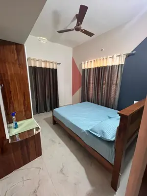 a bedroom with a bed and a ceiling fan at Aarvani Retreat Relax, Explore & Unwind in Coorg in Kushālnagar
