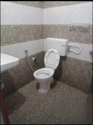 a bathroom with a toilet and a sink at Aswathy Bhavan in Vadakkāncheri
