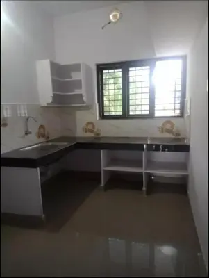 a kitchen with a sink and a window at Aswathy Bhavan in Vadakkāncheri