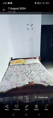 a picture of a bed in a room at Aswathy Bhavan in Vadakkāncheri