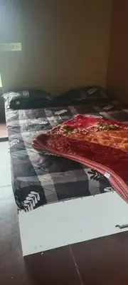 a bed with a blanket on top of it at Bison valley in Ooty