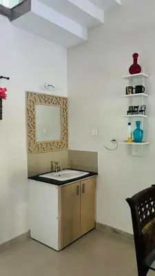 a bathroom with a sink and a mirror on the wall at Parthipuram in Thottada