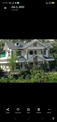 a picture of a large white house at Parthipuram in Thottada