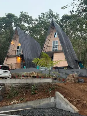 a house with two pointed roofs on top of it at Zerahs Private Pool Villa, Athirappilly - Extra upstair Bed space in Athirappally