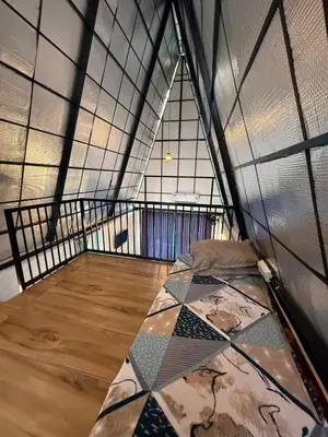 a room with a bed in the middle of a building at Zerahs Private Pool Villa, Athirappilly - Extra upstair Bed space in Athirappally