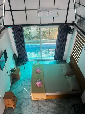 a room with a bed and a swimming pool at Zerahs Private Pool Villa, Athirappilly - Extra upstair Bed space in Athirappally