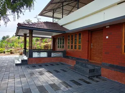 a red brick building with a pavilion on a patio at Valley De Hills Villa Room in Attappādi