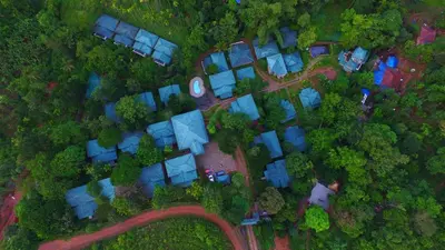 an overhead view of a group of houses with trees at Lakkidi village resort wayanad in Vythiri