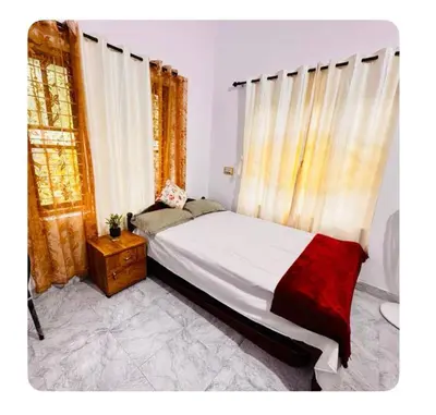 a bedroom with a large bed and a window at Nirvana Stays Banasura -Lotus in Wayanad