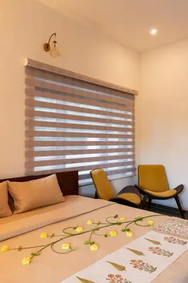 a bedroom with a bed with flowers on it at 1st Miracle By Mirth, Mythadi , Coorg in Ammatti