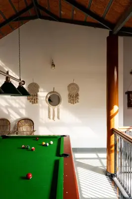 a pool table with balls on it in a room at 1st Miracle By Mirth, Mythadi , Coorg in Ammatti