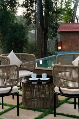 a patio with chairs and a table with cups on it at 1st Miracle By Mirth, Mythadi , Coorg in Ammatti