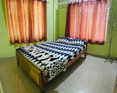 a bedroom with a bed in a room at Riverside Homestay Mankulam in Viripara