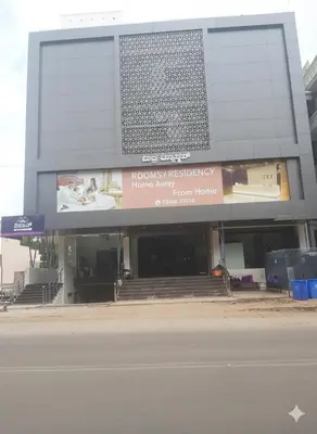 a building with a sign on the side of it at Mysore Comforts Stay in Mysore
