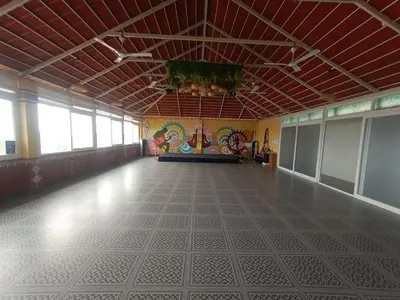 a large empty room with a tile floor and a ceiling at Mysore Comforts Stay in Mysore