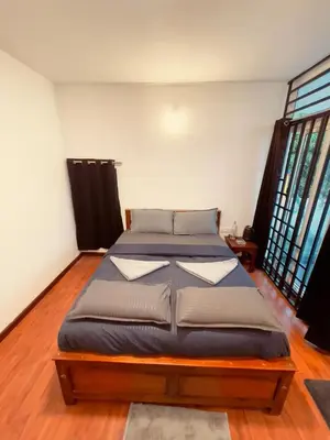 a bedroom with a large bed in a room at Vaj N Sat Villas in Kodaikānāl