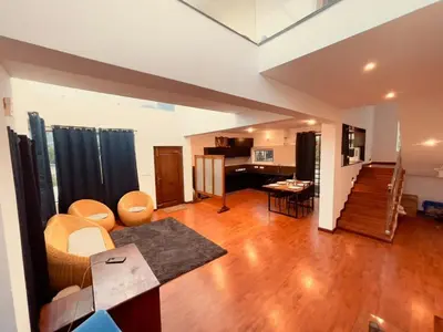 a living room with a couch and a table at Vaj N Sat Villas in Kodaikānāl