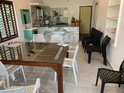 a dining room with a table and chairs at Elysian in Mananthavady