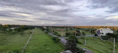 an aerial view of a field with a road at Campside Stays in Nāganahalli