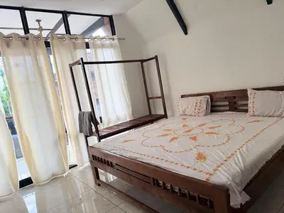 a bedroom with a bed and a large window at Kacchi Kombu Castle By Calpavruksha Estate in Madikeri