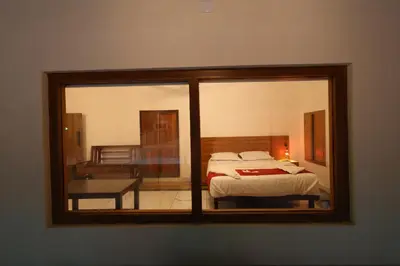 a bedroom with a bed and a window at Vayuvana Heritage Organic Farm Resort in Panamaram