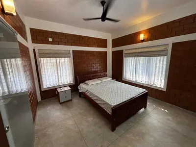 a bedroom with a bed and a ceiling fan at 3 bhk Premium home Stay at Ernakulam Aluva Perfect for Family and Long stay in Alwaye