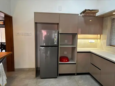a kitchen with a stainless steel refrigerator in it at 3 bhk Premium home Stay at Ernakulam Aluva Perfect for Family and Long stay in Alwaye