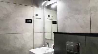 a bathroom with a sink and a mirror at Couple friendly apartment in Kozhikode