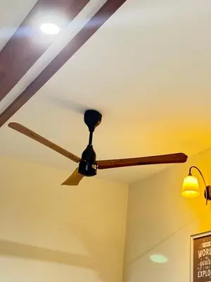 a ceiling fan and a light on a ceiling at Couple friendly apartment in Kozhikode