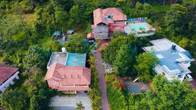 an overhead view of a house with a yard at Girassol Serviced Villa in Vythiri